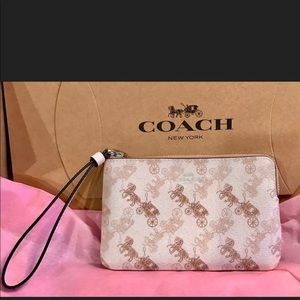 COACH Horse and carriage cream & beige wristlet
